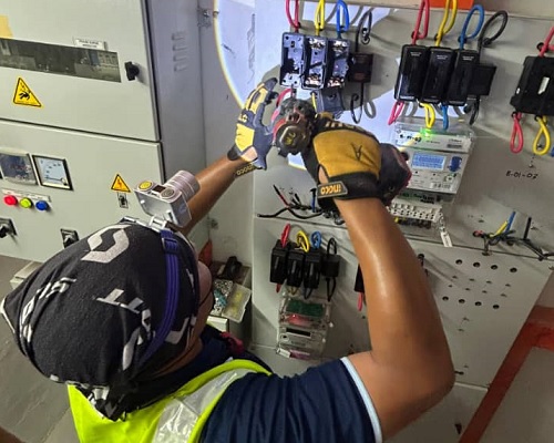 Technician memeriksa panel meter TNB